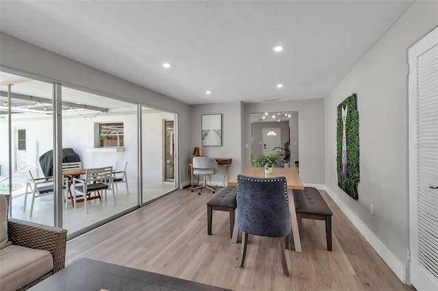 dining space with recessed lighting, light wood finished floors, plenty of natural light, and baseboards