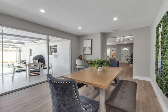 dining space featuring visible vents, baseboards, a notable chandelier, recessed lighting, and light wood-style flooring