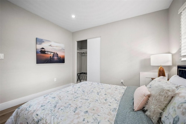 bedroom featuring baseboards, a closet, recessed lighting, and wood finished floors