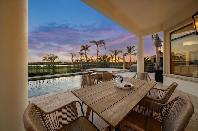 5830 Jamila River Dr, Venice, FL 34293 - balcony at dusk featuring outdoor dining area and a patio area