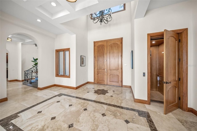 5830 Jamila River Dr, Venice, FL 34293 - foyer featuring recessed lighting, a high ceiling, arched walkways, baseboards, and a notable chandelier