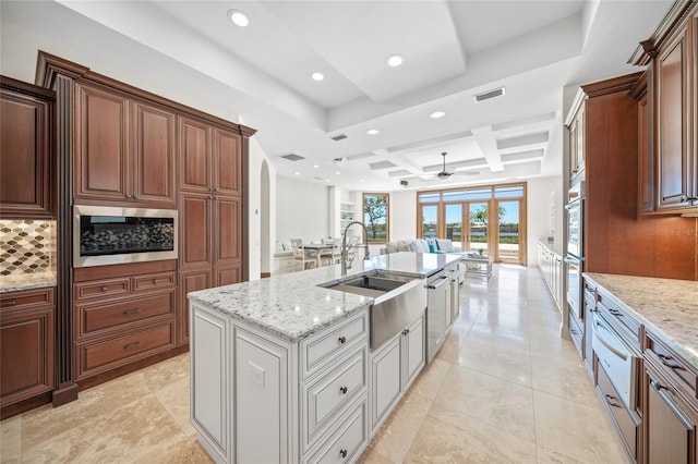 5830 Jamila River Dr, Venice, FL 34293 - kitchen with open floor plan, ceiling fan, backsplash, coffered ceiling, and visible vents