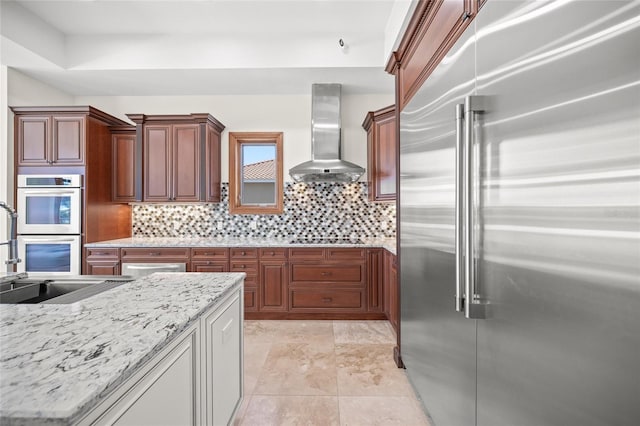 5830 Jamila River Dr, Venice, FL 34293 - kitchen with a sink, tasteful backsplash, appliances with stainless steel finishes, and wall chimney range hood