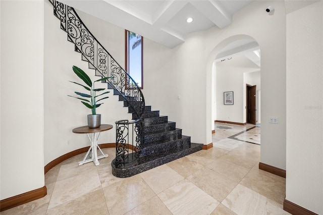 5830 Jamila River Dr, Venice, FL 34293 - stairs with arched walkways, baseboards, beamed ceiling, and recessed lighting