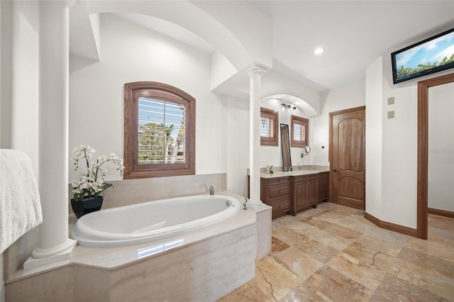 5830 Jamila River Dr, Venice, FL 34293 - bathroom with ornate columns, vanity, stone tile flooring, baseboards, and a garden tub