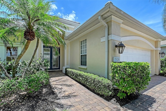 7528 Ascot Ct, Bradenton, FL 34201 - property entrance featuring stucco siding and an attached garage