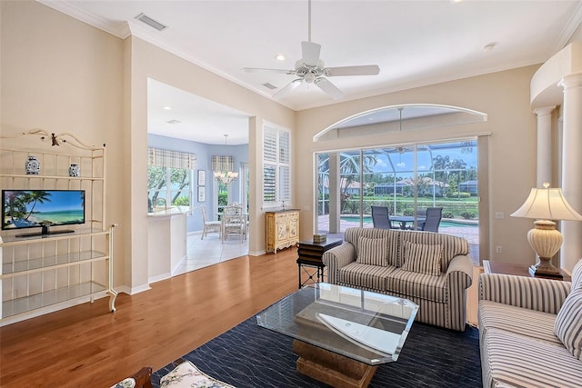 7528 Ascot Ct, Bradenton, FL 34201 - living area with healthy amount of natural light, ceiling fan, baseboards, a chandelier, and crown molding