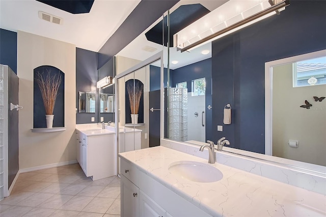 7528 Ascot Ct, Bradenton, FL 34201 - full bath with two vanities, tile patterned flooring, tiled shower, and baseboards