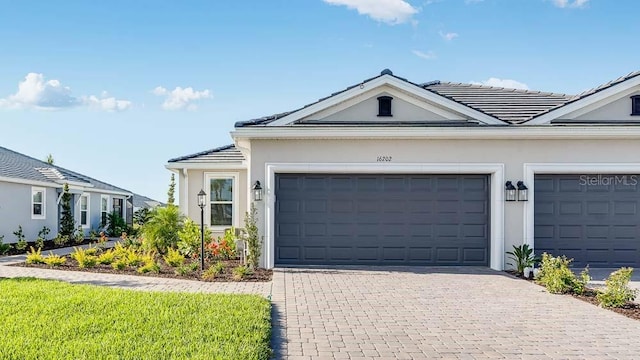 16202 Isola Pl, Bradenton, FL 34211 - view of front of property featuring a tile roof, driveway, stucco siding, and a garage