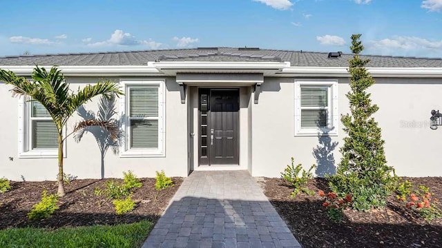 16202 Isola Pl, Bradenton, FL 34211 - entrance to property featuring stucco siding and a shingled roof