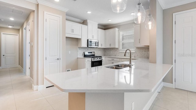 16202 Isola Pl, Bradenton, FL 34211 - kitchen featuring appliances with stainless steel finishes, a sink, ornamental molding, light tile patterned floors, and a peninsula