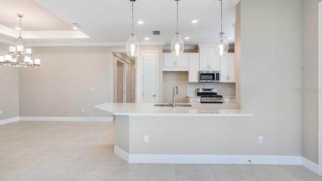 16202 Isola Pl, Bradenton, FL 34211 - kitchen with appliances with stainless steel finishes, a sink, crown molding, backsplash, and light countertops