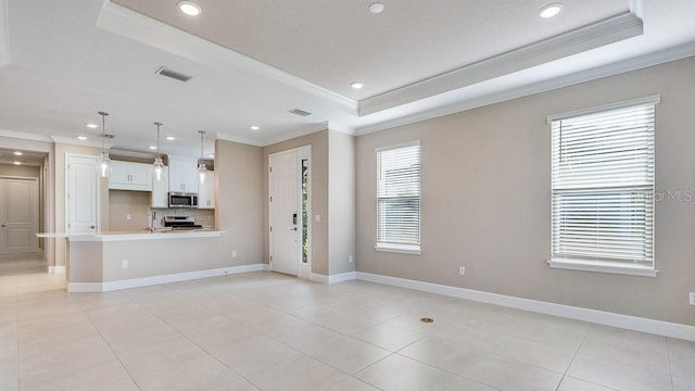 16202 Isola Pl, Bradenton, FL 34211 - unfurnished living room with ornamental molding, a tray ceiling, recessed lighting, baseboards, and light tile patterned flooring