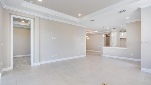 16202 Isola Pl, Bradenton, FL 34211 - unfurnished living room with a tray ceiling, crown molding, recessed lighting, baseboards, and light tile patterned floors