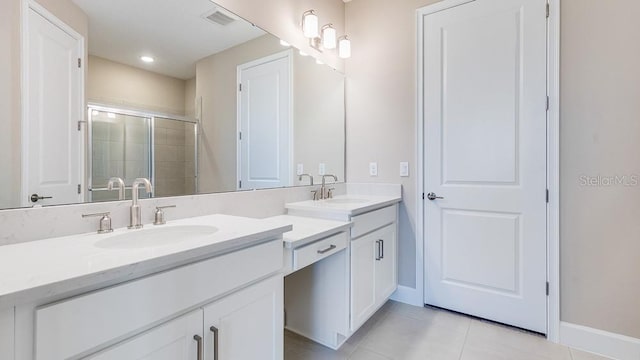 16202 Isola Pl, Bradenton, FL 34211 - full bathroom featuring tile patterned floors, a stall shower, double vanity, and baseboards