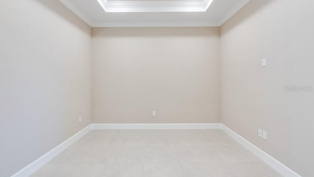 16202 Isola Pl, Bradenton, FL 34211 - spare room featuring crown molding, a raised ceiling, light tile patterned floors, and baseboards
