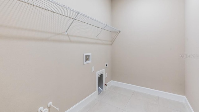 16202 Isola Pl, Bradenton, FL 34211 - clothes washing area with gas dryer hookup, hookup for a washing machine, light tile patterned floors, baseboards, and hookup for an electric dryer