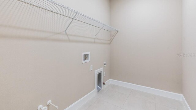 16202 Isola Pl, Bradenton, FL 34211 - clothes washing area with gas dryer hookup, hookup for a washing machine, light tile patterned floors, baseboards, and hookup for an electric dryer