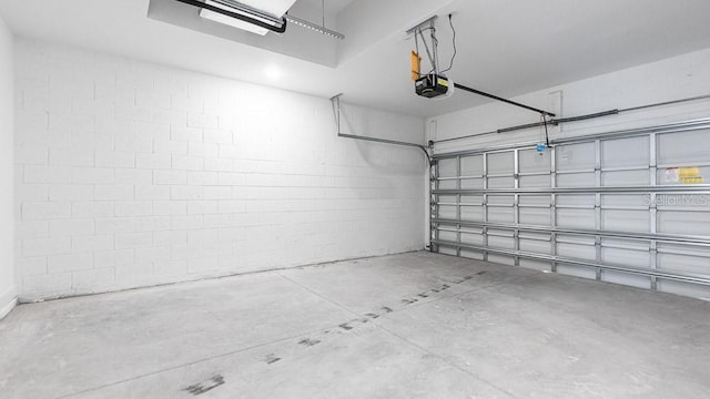 16202 Isola Pl, Bradenton, FL 34211 - garage featuring concrete block wall and a garage door opener