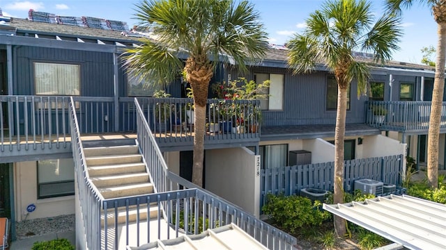 back of property featuring stairs and central AC unit