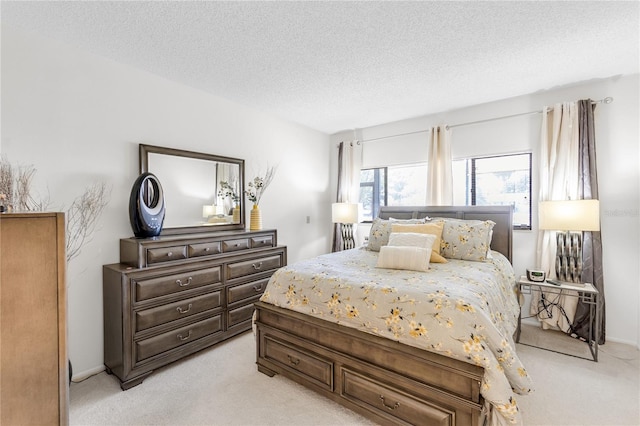 bedroom featuring light colored carpet and a textured ceiling