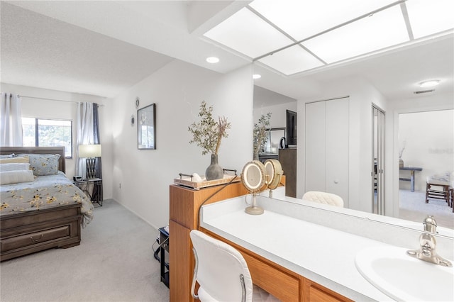 ensuite bathroom featuring visible vents, a sink, and connected bathroom
