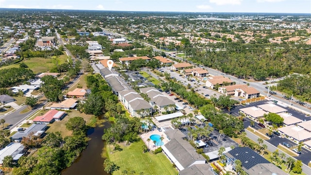 drone / aerial view featuring a water view and a residential view