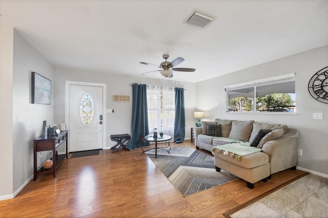 4243 Maceachen Blvd, Sarasota, FL 34233 - living area with wood finished floors, ceiling fan, baseboards, and visible vents