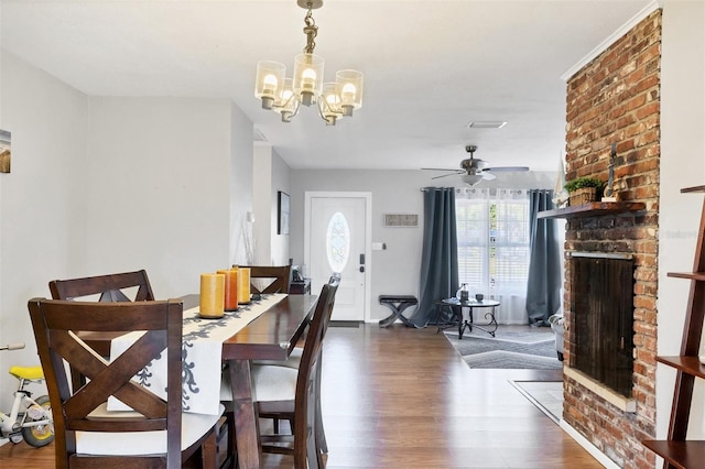 4243 Maceachen Blvd, Sarasota, FL 34233 - dining area featuring wood finished floors, ceiling fan with notable chandelier, a fireplace, and visible vents