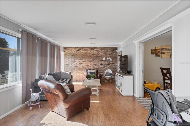 4243 Maceachen Blvd, Sarasota, FL 34233 - living room with brick wall and wood finished floors