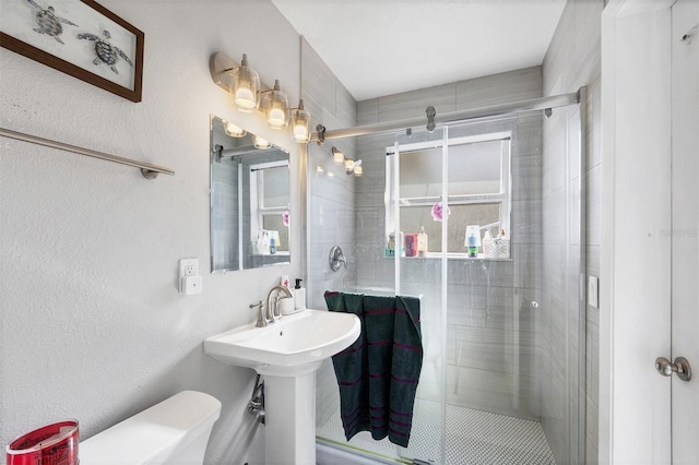 4243 Maceachen Blvd, Sarasota, FL 34233 - bathroom featuring a sink, toilet, and a stall shower