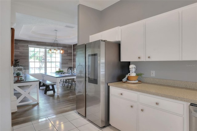 5810 Lake Victoria Dr, Lakeland, FL 33813 - kitchen with light tile patterned floors, light countertops, white cabinets, a raised ceiling, and smart refrigerator