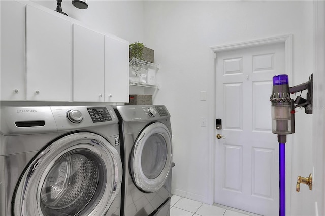 5810 Lake Victoria Dr, Lakeland, FL 33813 - laundry room with cabinet space, light tile patterned floors, washing machine and clothes dryer, and baseboards