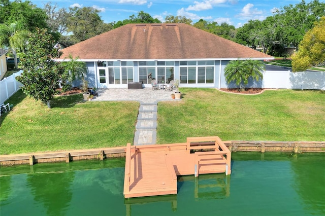 5810 Lake Victoria Dr, Lakeland, FL 33813 - back of house with a water view, fence, a lawn, and a patio area