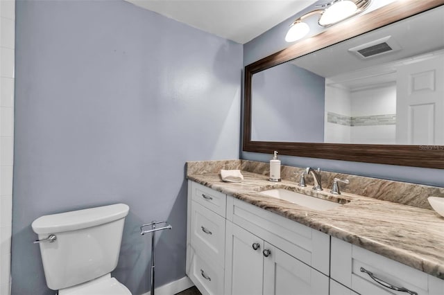 bathroom with toilet and vanity