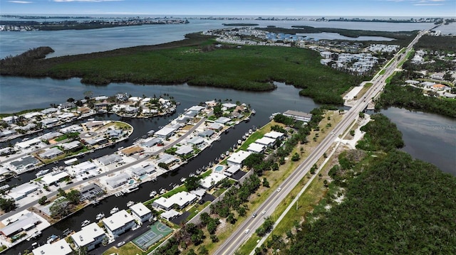 view of property location featuring a nearby body of water and nearby suburban area