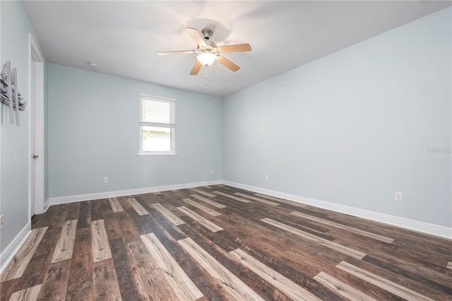 empty room featuring baseboards, wood finished floors, and a ceiling fan