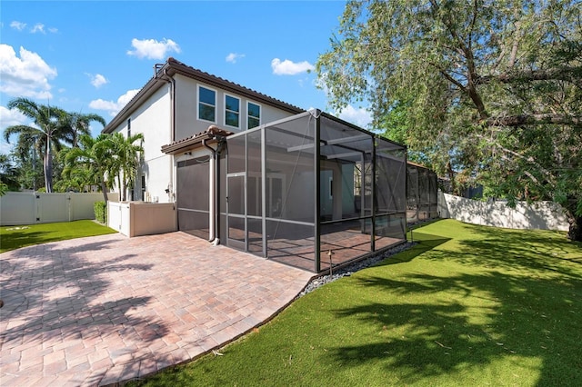 1719 Kenilworth St, Sarasota, FL 34231 - rear view of house featuring a patio, a fenced backyard, a garage, a gate, and a lanai