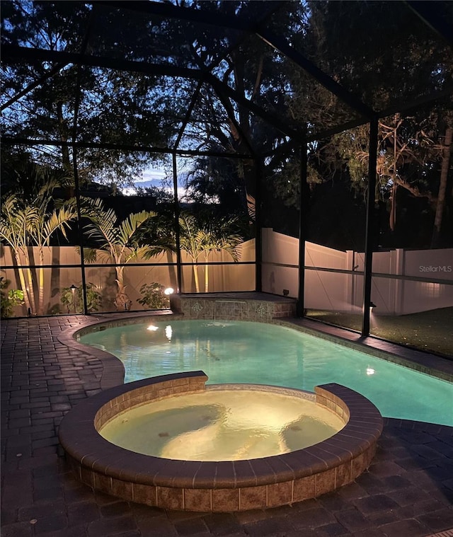 1719 Kenilworth St, Sarasota, FL 34231 - view of swimming pool featuring glass enclosure, a pool with connected hot tub, and a patio area