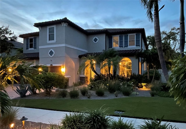 1719 Kenilworth St, Sarasota, FL 34231 - mediterranean / spanish house with stucco siding, a tile roof, and a front lawn