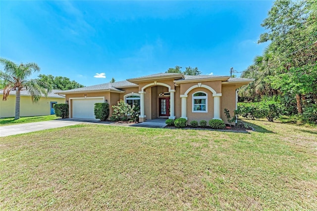 1631 Madison Ave, North Port, FL 34286 - view of front of home with concrete driveway, a front yard, stucco siding, and a garage