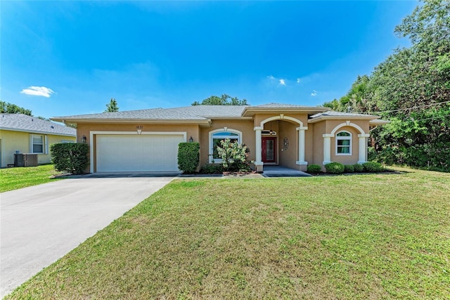 1631 Madison Ave, North Port, FL 34286 - view of front of property featuring a front lawn, concrete driveway, a garage, and stucco siding
