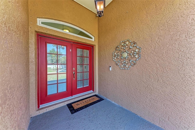 1631 Madison Ave, North Port, FL 34286 - doorway to property featuring french doors and stucco siding
