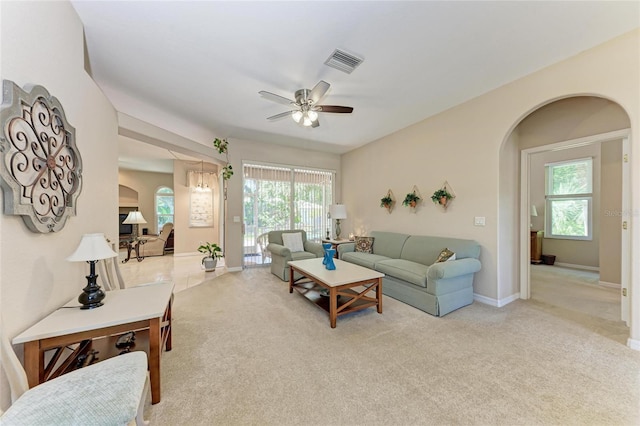1631 Madison Ave, North Port, FL 34286 - living room featuring ceiling fan, carpet, arched walkways, visible vents, and baseboards