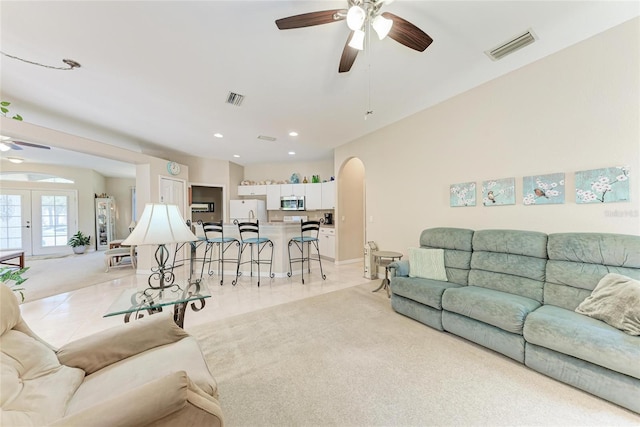 1631 Madison Ave, North Port, FL 34286 - living area with visible vents, a ceiling fan, arched walkways, and light colored carpet