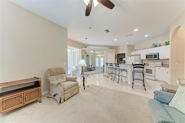 1631 Madison Ave, North Port, FL 34286 - living room featuring visible vents, baseboards, arched walkways, a ceiling fan, and recessed lighting