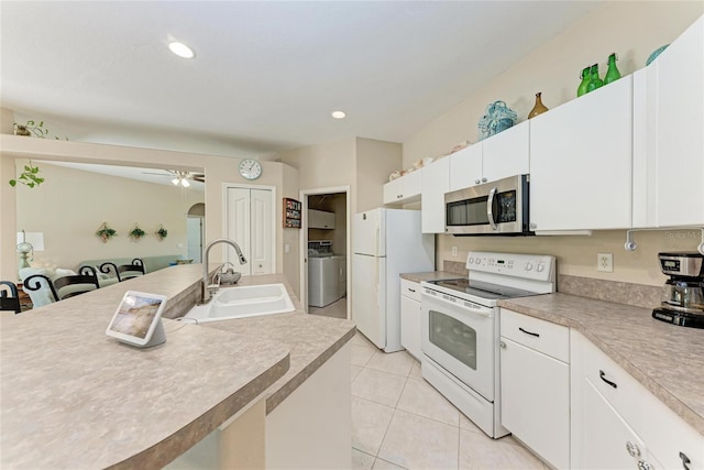 1631 Madison Ave, North Port, FL 34286 - kitchen featuring white appliances, light tile patterned floors, white cabinets, ceiling fan, and a sink