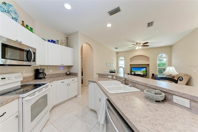 1631 Madison Ave, North Port, FL 34286 - kitchen featuring light tile patterned floors, visible vents, arched walkways, a sink, and stainless steel appliances