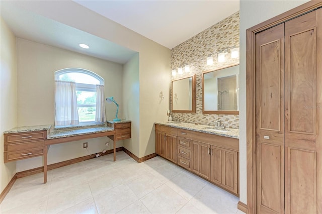 1631 Madison Ave, North Port, FL 34286 - bathroom featuring double vanity, baseboards, a sink, and backsplash