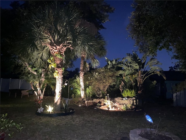 1631 Madison Ave, North Port, FL 34286 - yard at night featuring an outdoor fire pit and fence